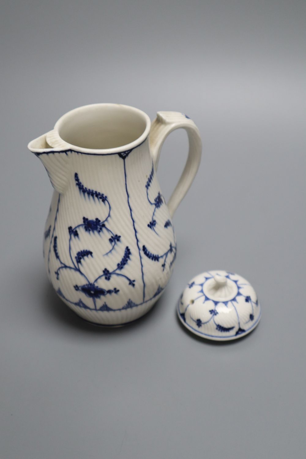 A Tournai covered jug and a similar coffee cup, c.1770 and a similar Zurich puce saucer, c.1775 (4), jug 16cm, ex Klaber & Klaber